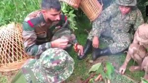 Indian soldiers learn techniques to light fire in jungle from Malaysian troopers.