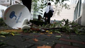 Woman killed as typhoon Faxai lashes Tokyo area, cutting power and transport.