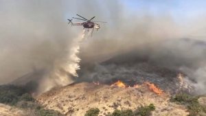 Southern California endures second straight day of wind-stoked wildfires.