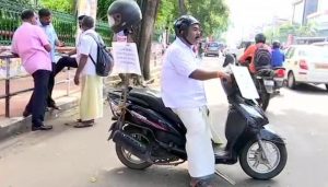 Shiv Sena leader protests fines against violation of helmet rules in Kerala