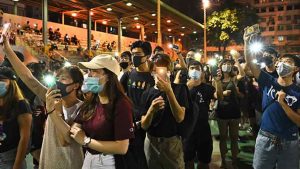 Police arrest organiser of Hong Kong protest after rally turns violent.